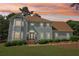 Charming two-story home with an arched front door and manicured landscaping at 771 James Cir, Lawrenceville, GA 30046