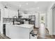 Modern kitchen with white cabinets, stainless steel appliances, stone countertops and eat in island at 771 James Cir, Lawrenceville, GA 30046