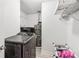 A tidy laundry room with washer, dryer, water heater, and ample shelving at 771 James Cir, Lawrenceville, GA 30046