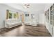 Bright living room with modern floors, white couches, and a view of the back yard at 771 James Cir, Lawrenceville, GA 30046