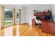 Bright office space featuring gleaming hardwood floors, a large window, and a built-in desk at 771 James Cir, Lawrenceville, GA 30046