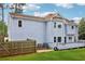Rear view of the home, showcasing deck, fenced yard, and exterior features at 771 James Cir, Lawrenceville, GA 30046