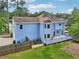 Aerial view of the home's blue rear exterior with a spacious wooden deck and a fenced-in yard at 771 James Cir, Lawrenceville, GA 30046