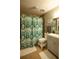 Bathroom features a vanity, a shower with a patterned curtain, and tiled flooring at 1025 Mcgill Park Ne Ave, Atlanta, GA 30312