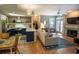 Living room flowing into updated kitchen, with fireplace, hardwood floors and natural light at 1025 Mcgill Park Ne Ave, Atlanta, GA 30312
