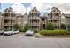 Exterior view of a condo building and parking lot on a cloudy day at 1025 Mcgill Park Ne Ave, Atlanta, GA 30312