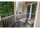 Outdoor porch features two chairs and a small table with a view of a neighborhood tree at 1025 Mcgill Park Ne Ave, Atlanta, GA 30312