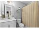 Clean bathroom with white vanity and shower with decorative curtain at 250 Castleberry Station Sw Dr, Atlanta, GA 30313