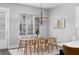 Dining area featuring modern light fixture, table and chairs, and light-filled space at 250 Castleberry Station Sw Dr, Atlanta, GA 30313