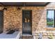 Charming front entrance with a decorative wreath, brick facade, and updated lighting at 250 Castleberry Station Sw Dr, Atlanta, GA 30313