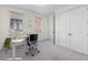 Home office with modern desk, neutral carpet, and natural light from two windows at 250 Castleberry Station Sw Dr, Atlanta, GA 30313