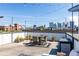 Relaxing rooftop deck with views of Atlanta, string lights, and stylish outdoor furniture at 250 Castleberry Station Sw Dr, Atlanta, GA 30313