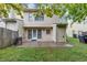 A backyard featuring a small patio, a grassy area, and a storage shed attached to the house at 2682 Arbor Glen Pl., Marietta, GA 30066