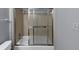 Bathroom featuring a bathtub with sliding glass doors and neutral colored tile at 2682 Arbor Glen Pl., Marietta, GA 30066