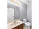 Bathroom with white toilet, vanity, and large mirror at 2682 Arbor Glen Pl., Marietta, GA 30066