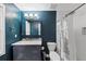 Updated bathroom featuring blue accent wall, white tile, and modern fixtures at 2682 Arbor Glen Pl., Marietta, GA 30066