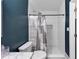 Updated bathroom with blue accent wall, white tile, and tiled shower with a shower curtain at 2682 Arbor Glen Pl., Marietta, GA 30066