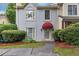 Charming townhome with a red awning over the front door and manicured landscaping at 2682 Arbor Glen Pl., Marietta, GA 30066