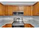 A kitchen with stainless steel appliances and wood cabinets at 2682 Arbor Glen Pl., Marietta, GA 30066