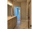 Bathroom with double sink vanity, shower and tile floor near walk through to bedroom at 3708 Cheswolde Ave, Powder Springs, GA 30127