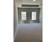 Neutral carpeted bedroom features tray ceiling and two windows at 3708 Cheswolde Ave, Powder Springs, GA 30127
