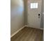 Entryway with a white door and sidelight on wood-look flooring at 3708 Cheswolde Ave, Powder Springs, GA 30127