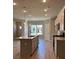 Spacious kitchen featuring a large island, stainless steel appliances, and wood floors at 3708 Cheswolde Ave, Powder Springs, GA 30127