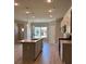 Open-concept kitchen with modern cabinetry, stainless steel appliances, and center island at 3708 Cheswolde Ave, Powder Springs, GA 30127