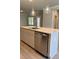 Kitchen island featuring stone countertops, stainless steel appliances, and pendant lighting at 3708 Cheswolde Ave, Powder Springs, GA 30127