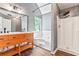Stylish bathroom featuring a dual sink vanity, soaking tub with tile surround, and a glass-enclosed shower at 4148 Kings Cswy, Ellenwood, GA 30294