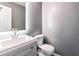 Modern bathroom with a vanity, a decorative mirror with vanity lighting and a toilet with grey walls at 4148 Kings Cswy, Ellenwood, GA 30294