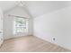 Bright bedroom features vaulted ceilings, light-colored flooring, and a large window providing natural light at 4148 Kings Cswy, Ellenwood, GA 30294
