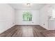 Dining room features hardwood floors, neutral paint, decorative molding and a large window for natural light at 4148 Kings Cswy, Ellenwood, GA 30294