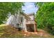 Back view of house with a wooden deck and partially shaded backyard at 4148 Kings Cswy, Ellenwood, GA 30294