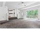 Open living space with carpet flooring, large window, and access to the kitchen at 4148 Kings Cswy, Ellenwood, GA 30294