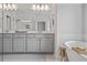 Beautiful bathroom featuring double vanity, a soaking tub, and modern fixtures, perfect for relaxation at 820 Kenway Ave, Roswell, GA 30076