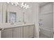 Clean and bright bathroom with double sinks, modern fixtures, and a combined tub and shower at 820 Kenway Ave, Roswell, GA 30076