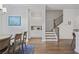 Dining area adjacent to the kitchen featuring a wooden table, seating, and a staircase at 820 Kenway Ave, Roswell, GA 30076