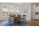 Dining room with a wooden table set, and natural light from windows and a chandelier at 820 Kenway Ave, Roswell, GA 30076