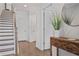 Inviting entryway with hardwood floors, staircase, console table and decorative mirror at 820 Kenway Ave, Roswell, GA 30076