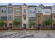 Charming townhomes boasting brick and siding exteriors, manicured lawns, and stylish architectural details at 820 Kenway Ave, Roswell, GA 30076