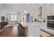 Bright, open kitchen featuring a large island, stainless steel appliances, and stylish pendant lighting at 820 Kenway Ave, Roswell, GA 30076