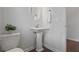 Neat powder room featuring a pedestal sink, modern fixtures, and minimalist design at 820 Kenway Ave, Roswell, GA 30076