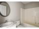 Bathroom featuring a tub and shower, single vanity and round mirror for a bright and clean look at 175 Hearth Way, Fairburn, GA 30213