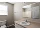 Bathroom featuring a single sink vanity, tiled floors and a window for natural light at 175 Hearth Way, Fairburn, GA 30213