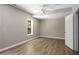 Spacious bedroom featuring wood-look floors, natural light, ceiling fan and neutral colored walls at 175 Hearth Way, Fairburn, GA 30213