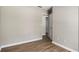 Bedroom featuring wood-look floors, neutral walls, ceiling fan, and a bright window at 175 Hearth Way, Fairburn, GA 30213