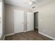 Bedroom with wood-look floors and neutral walls with two white doors and bright window at 175 Hearth Way, Fairburn, GA 30213