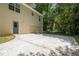 Exterior shot of a house showing driveway leading to a garage with trees in the background at 175 Hearth Way, Fairburn, GA 30213