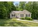 Charming single-story home with well-maintained lawn and mature landscaping, and concrete walkway at 175 Hearth Way, Fairburn, GA 30213
